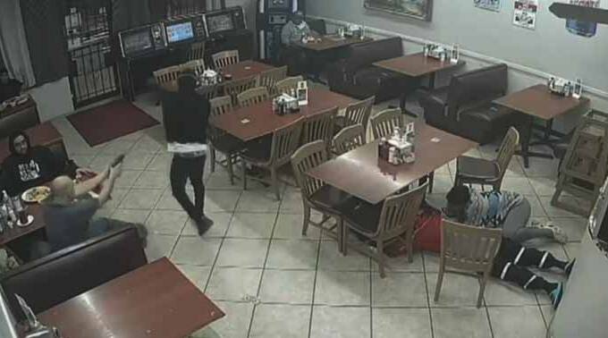 The customer opens fire on the suspect from the back