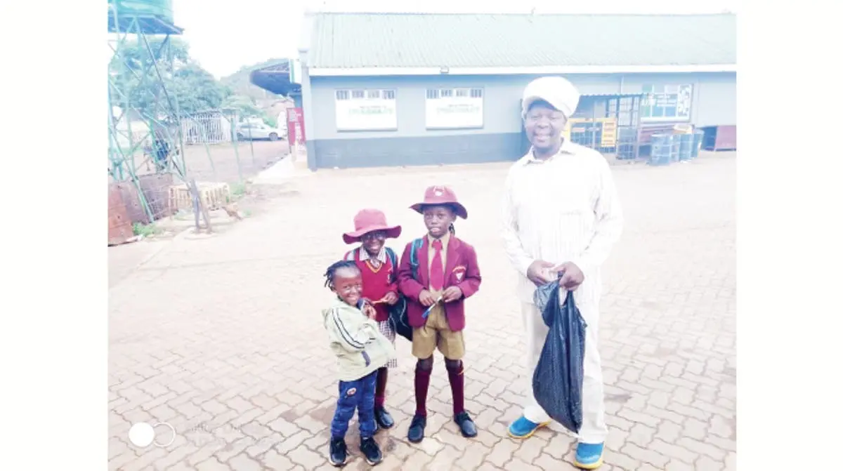 Farai Kambamura with his children the eldest is Jesus one standing next to the father on the left side, girl is Mbuya Nehanda and Mugabe without uniform