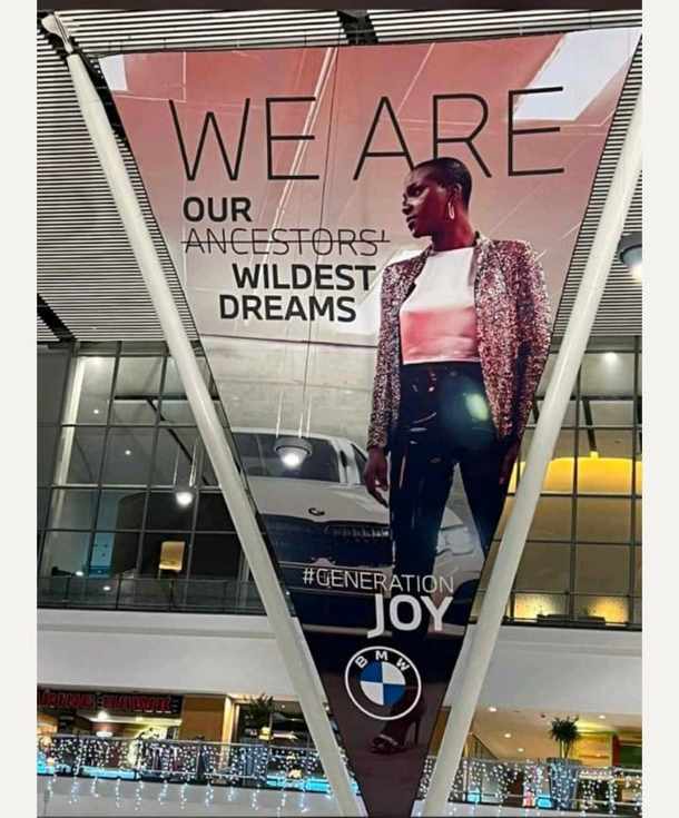 The latest BMW advert featured a black woman standing next to one of the brand’s latest BMW 5 Series models, and displayed behind her, is the phrase, ‘We Are Our Ancestors’ Wildest Dreams’, with the word ‘ancestors’ crossed out.