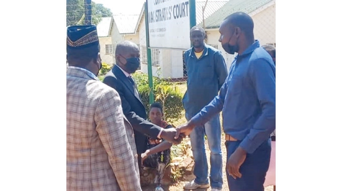 Paradzai Mesi shaking hands with Never Sabau