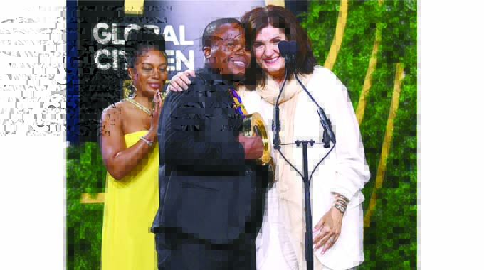 Nkosana Butholenkosi and Fran Katsoudas in New York, behind them is South African celebrity Nomzamo Mbatha